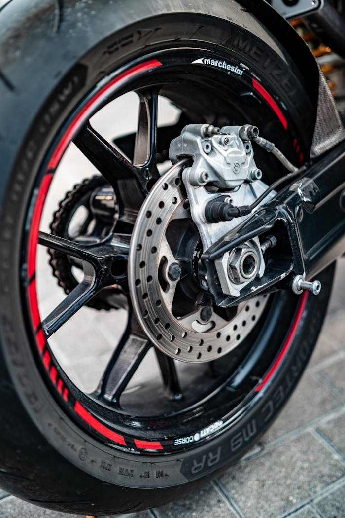 Detailed view of a motorcycle's rear wheel showing the brake disc and rim design.